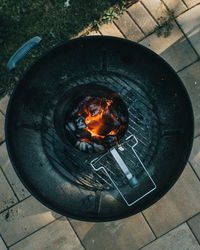 High angle view of fire in container