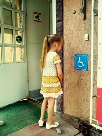 Full length of woman standing by railing