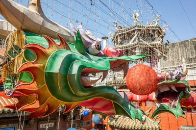 Low angle view of carousel statue against sky