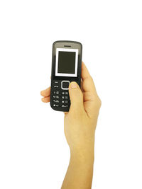 Close-up of hand holding smart phone over white background