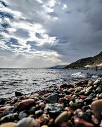 Rocks on beach against sky