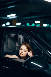 Portrait of young woman in car