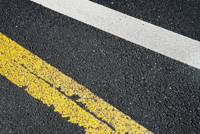 High angle view of yellow sign on road