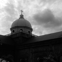 Exterior of historic church against cloudy sky