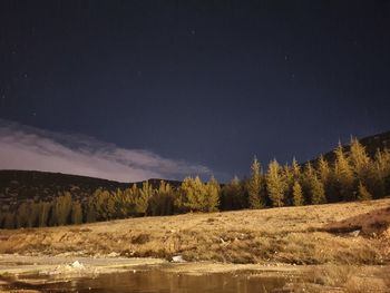 Scenic view of lake against sky at night