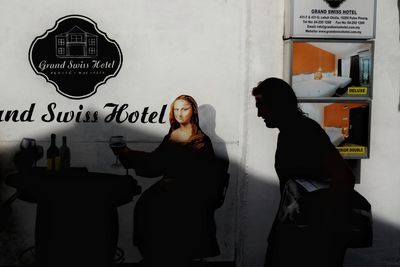 Friends standing against wall