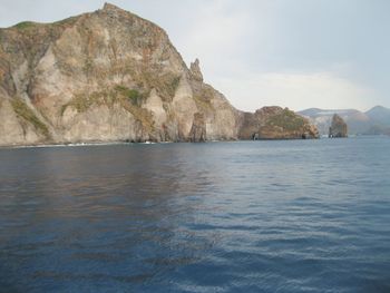 Scenic view of sea and mountains against sky