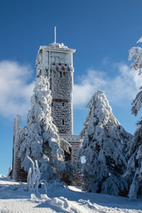 Low angle view of buildings against sky during winter