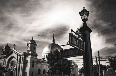 Low angle view of buildings against cloudy sky