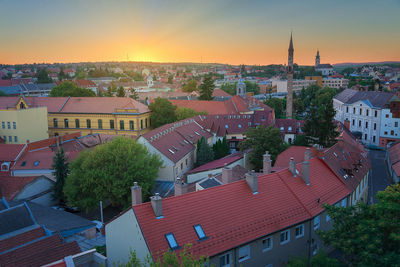 Aerial view of town against sky at sunset