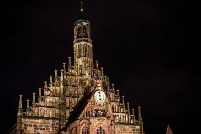 Low angle view of illuminated woman church against sky at night in city of nuremberg