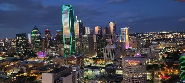 Illuminated cityscape against sky at night