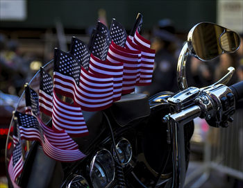 Close-up of small american flags on motorcycle handlebar