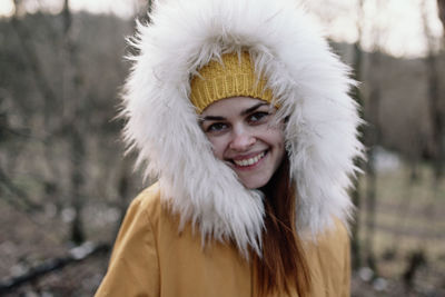 Portrait of woman wearing warm clothing standing outdoors