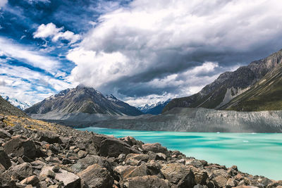 Scenic view of lake by mountains against sky