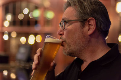 Man drinking beer from glass