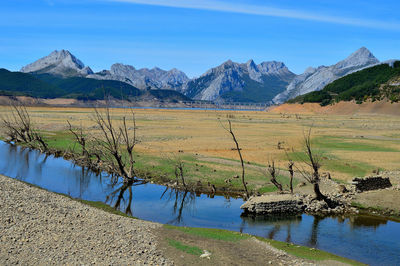 Scenic view of lake and mountains against sky