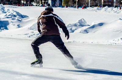Rear view of man in snow