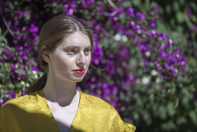 Close-up of woman against purple flowering plants