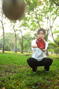 Rear view of woman sitting on field