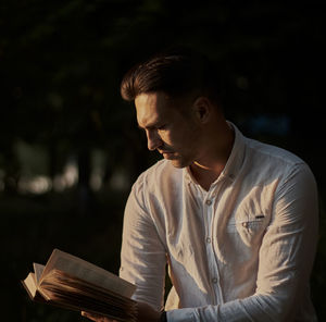 Young man looking at book