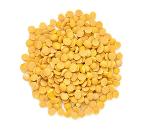 Yellow lentils over white background