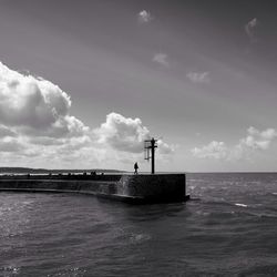 Scenic view of sea against cloudy sky