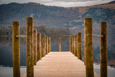 Rear view of man walking on boardwalk