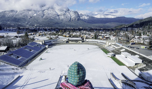 High angle view of woman standing against snowcapped mountains in city