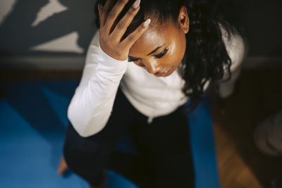 Close-up of woman standing against wall