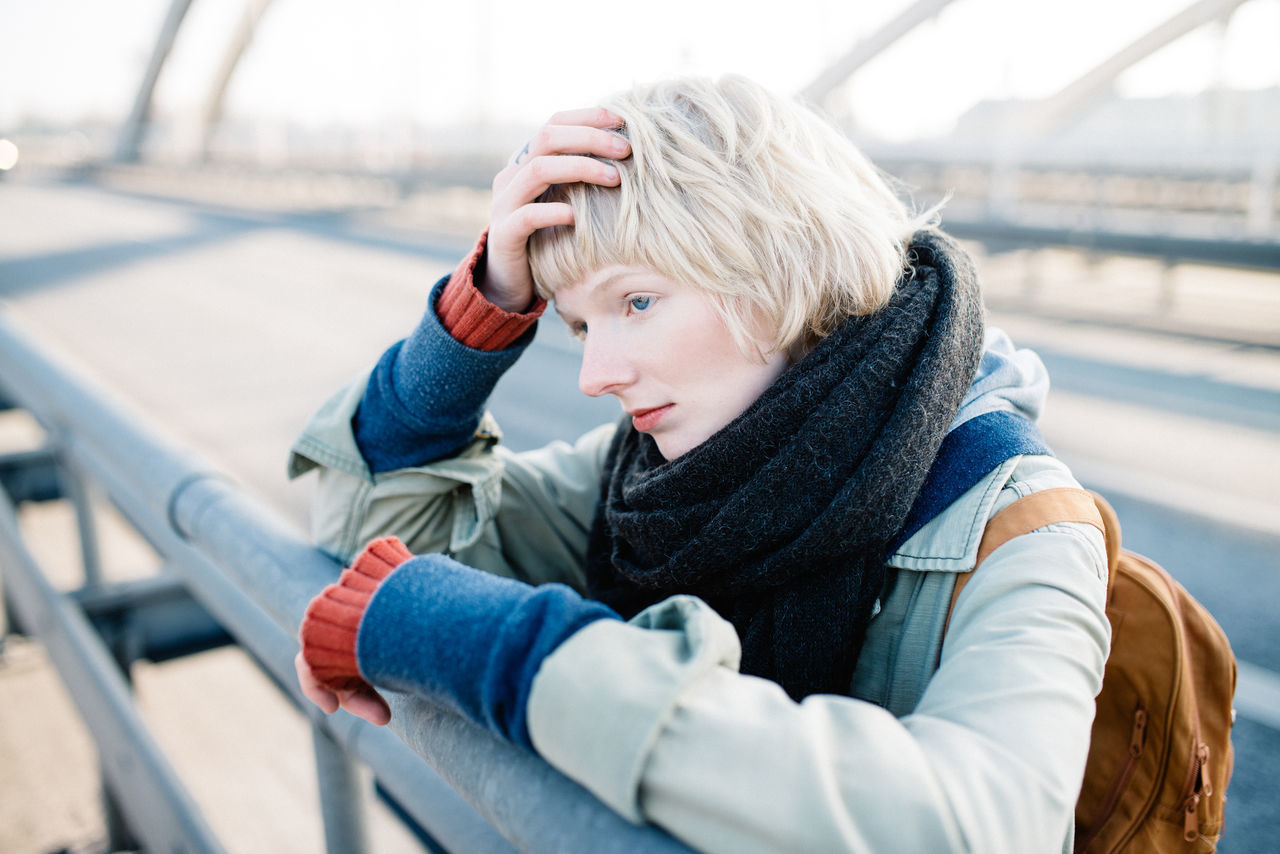 Sad woman standing on bridge