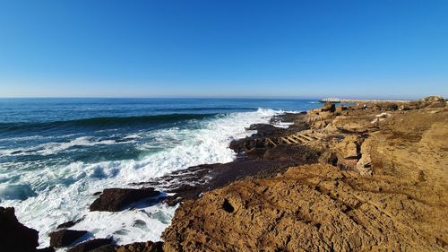 Scenic view of sea against clear blue sky