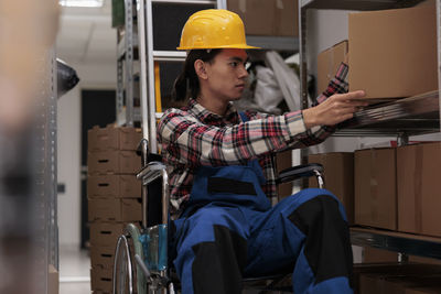 Rear view of man working in factory