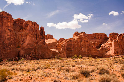 Rock formations on landscape against cloudy sky