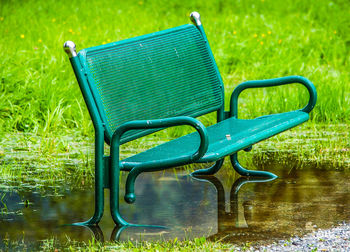 Chairs on grass in water