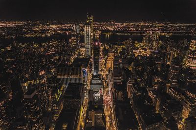High angle view of city lit up at night
