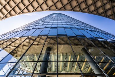 Low angle view of modern building against blue sky