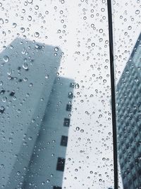 Road seen through wet glass window
