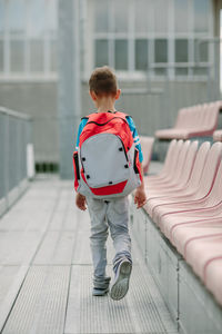 Rear view of boy walking in stadium