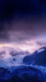 Scenic view of snow covered mountains against sky