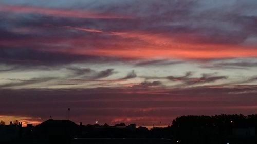 Silhouette buildings against sky during sunset