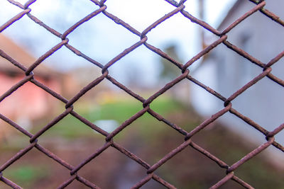 Full frame shot of chainlink fence against sky