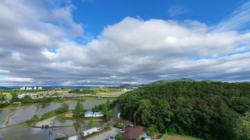 High angle view of trees and buildings against sky