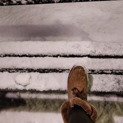 Close-up of man standing on snow