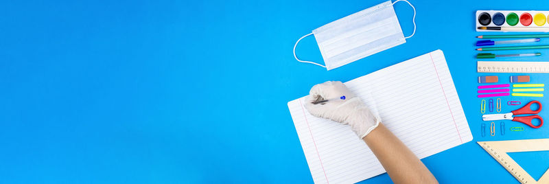 Close-up of books against blue wall