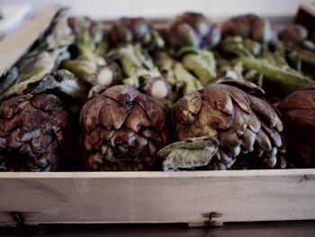 Close-up of artichokes in container