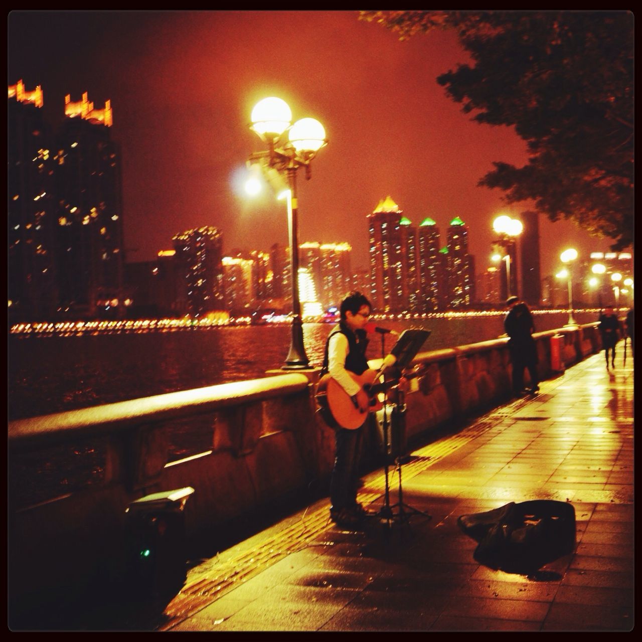 building exterior, city, architecture, illuminated, built structure, night, transfer print, city life, cityscape, auto post production filter, skyscraper, street light, men, sky, street, sitting, lighting equipment, lifestyles