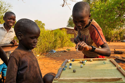 Siblings playing on farm