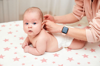 Midsection of mother massaging daughter