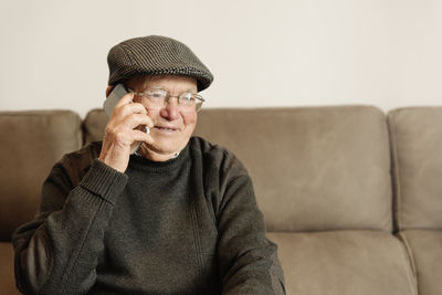 Portrait of man sitting on sofa